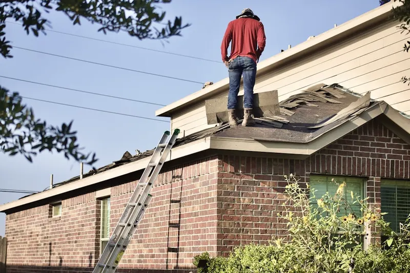 Professional roofer working on a residential roof in Lions Gate II